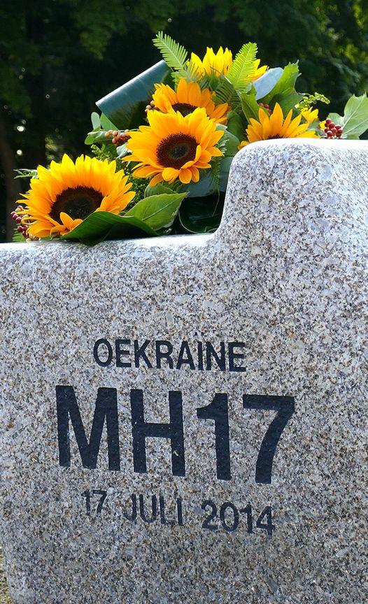 Bankje bij monument met zonnebloemen